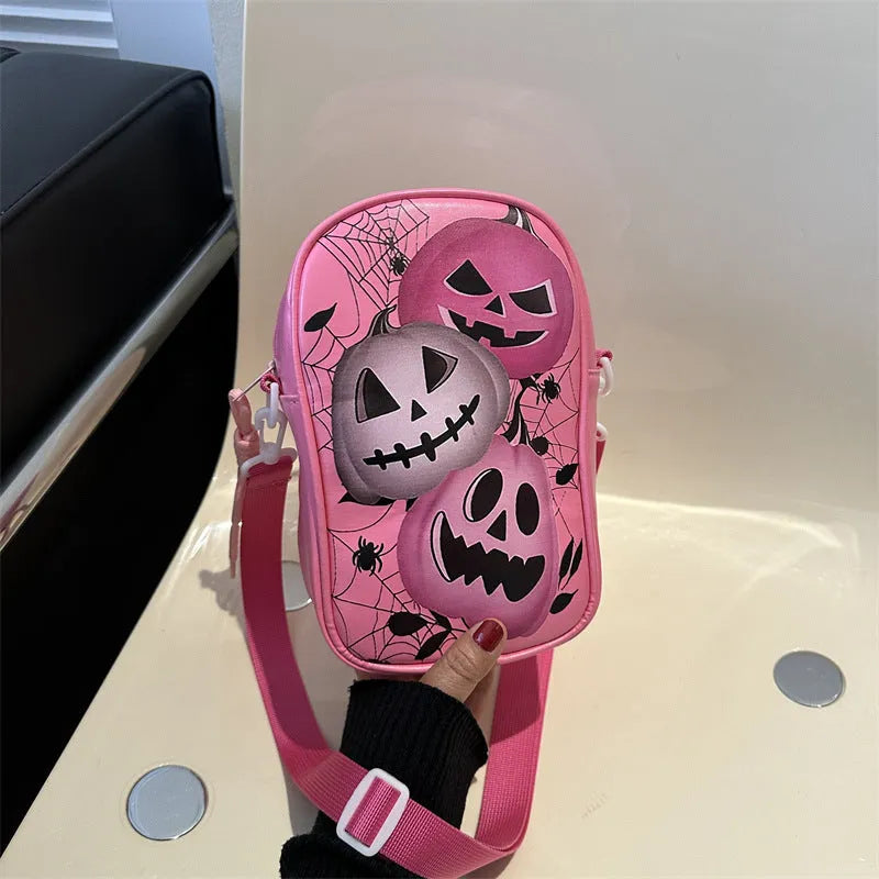 Black Halloween graffiti crossbody bag with cartoon pumpkin, ghost, and bat print, shown with adjustable strap.