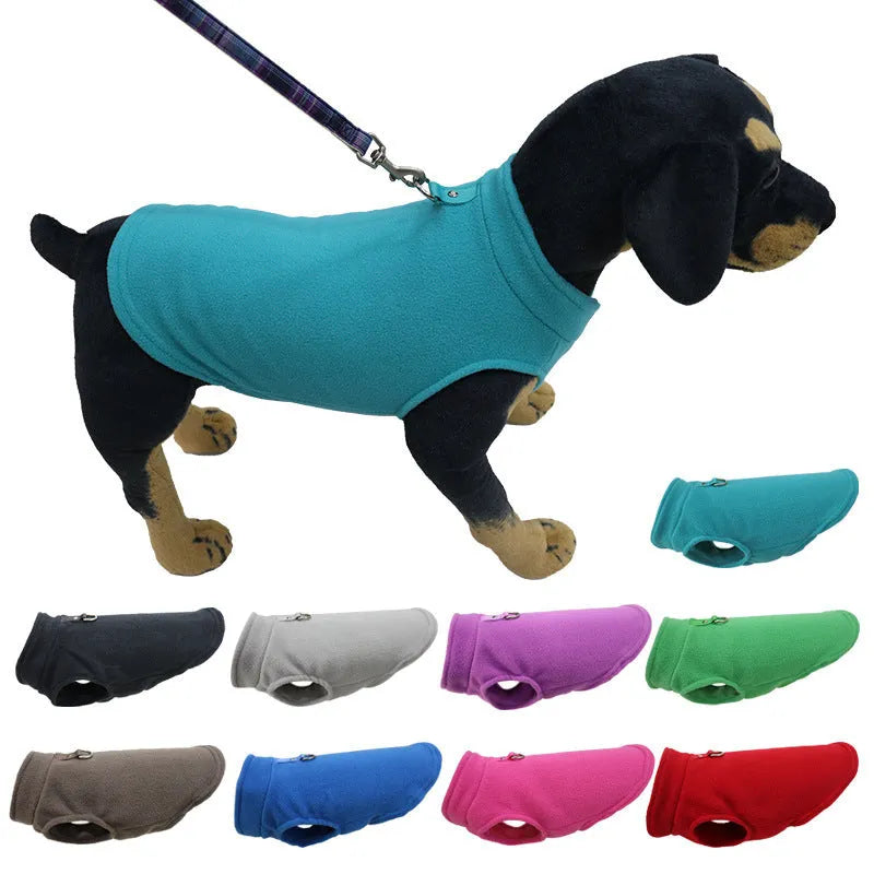 A dog wearing a solid red polar fleece waistcoat, showing the vest-style design for warmth.