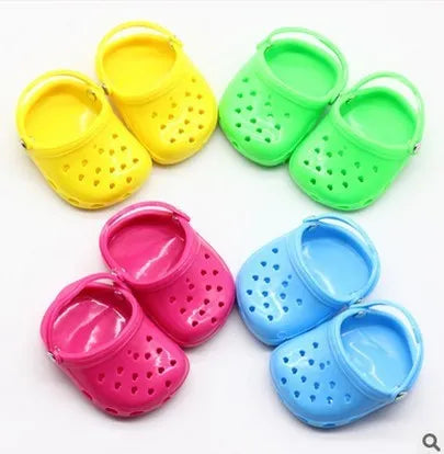 Blue, red, yellow, and green plastic doll beach slippers fashion accessory.