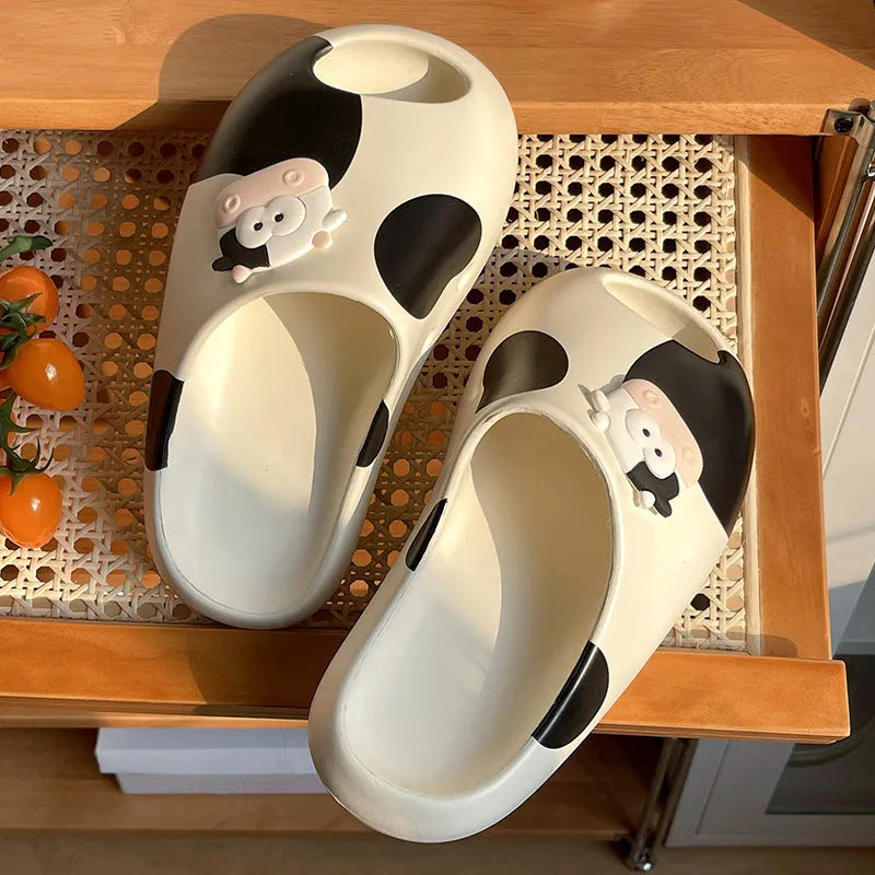 Thick-soled cartoon cow print EVA flip flops in black and white