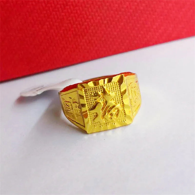 Square men's alloy ring with electroplated yellow finish on plain background