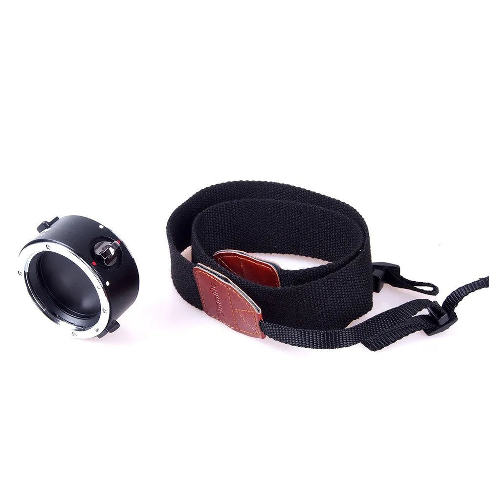 Aluminium camera lens flipper holder with cotton shoulder strap for quick lens changes on Nikon, Canon, or Sony cameras.