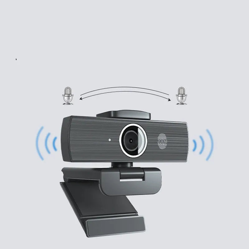 Black USB computer webcam with a magnetic privacy cover on a desk.
