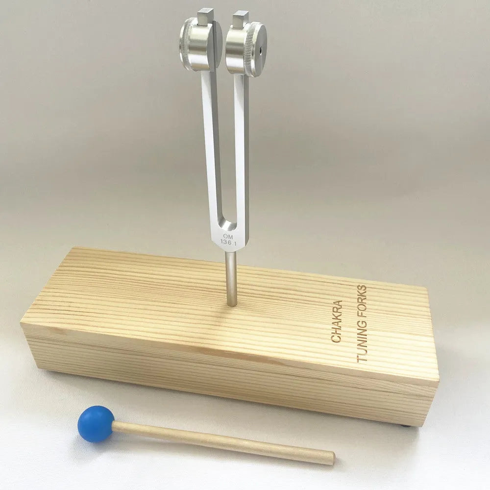 Aluminium alloy 432Hz tuning fork and speaker set on a kraft paper box.