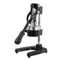 Black and white manual cast iron juice press with stainless steel funnel, standing 40cm high.