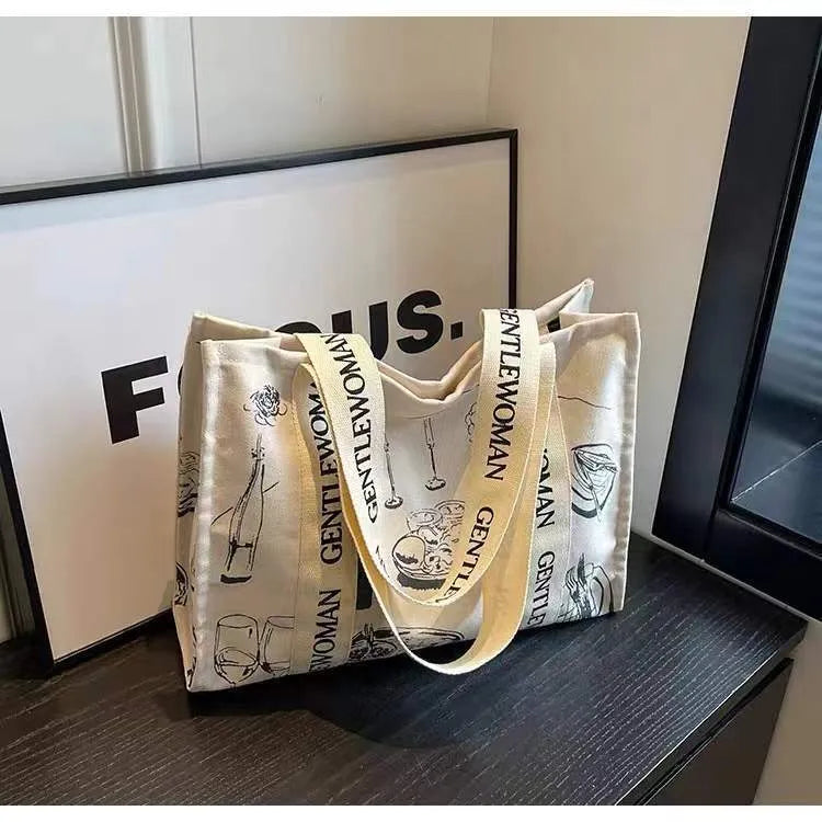 Canvas women's travel tote bag with printed design options including black letters, coloured letters, and pattern styles