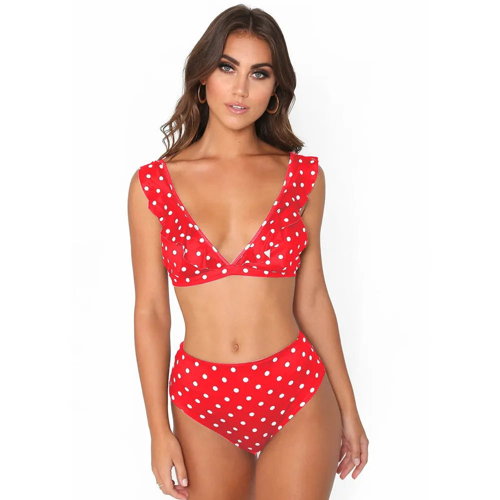 Women's black and white polka dot bikini set with ruffled deep V-neck top and matching shorts