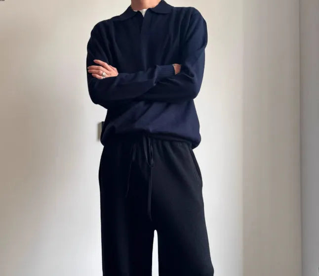 Milky white pure wool lapel collar polo sweater laid flat, showing loose fit and long sleeves.
