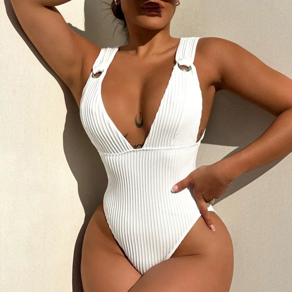 Women's solid colour one-piece swimsuit on a hanger, available in black, white, green, and orange.