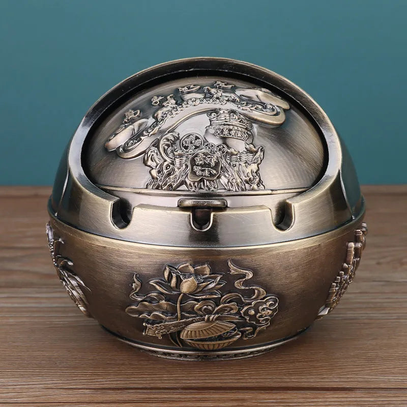 Bronze and red copper alloy decorative ashtray with smoke-extinguishing slot on a table.