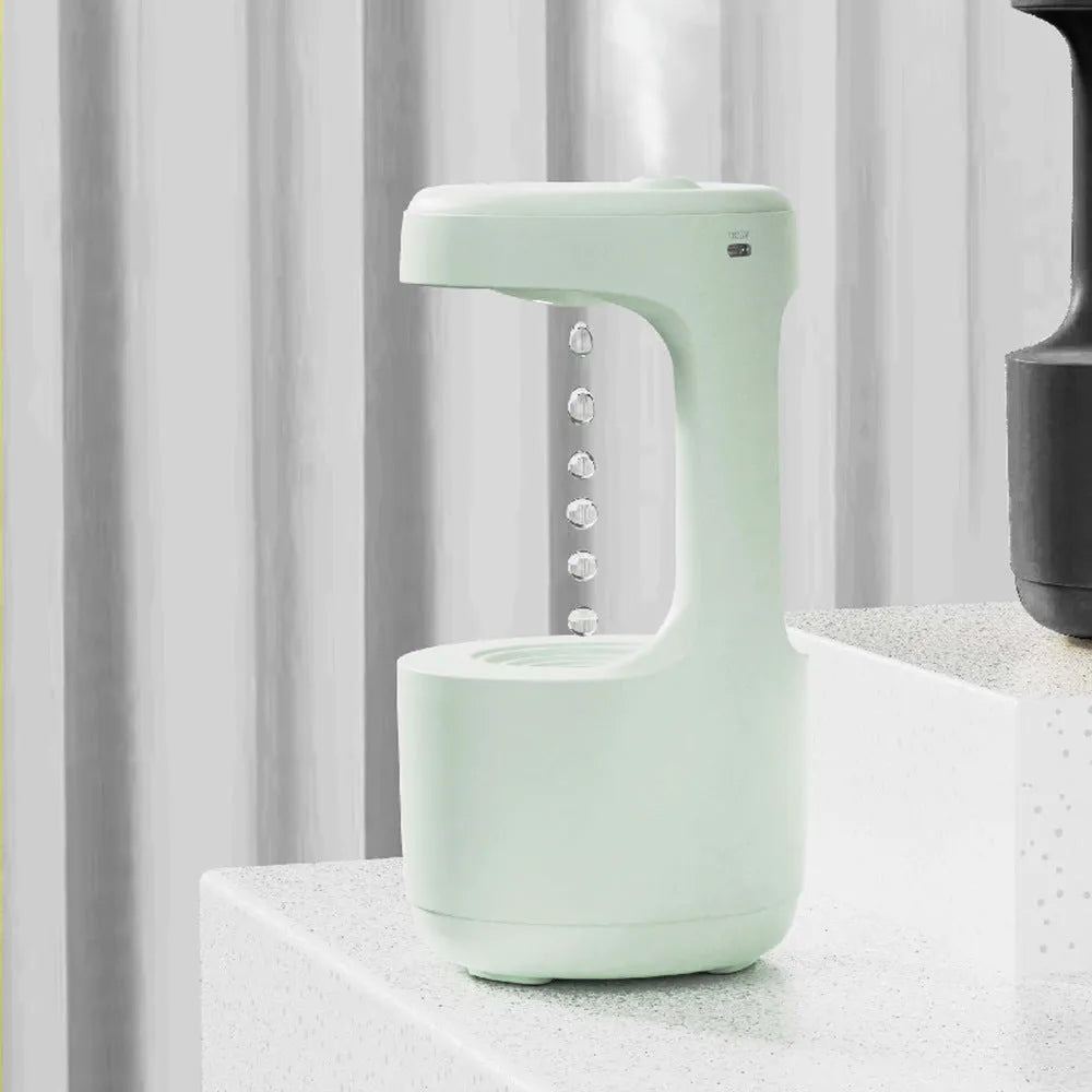 White columnar anti-gravity humidifier with LED clock display and mist output on a wooden desk.