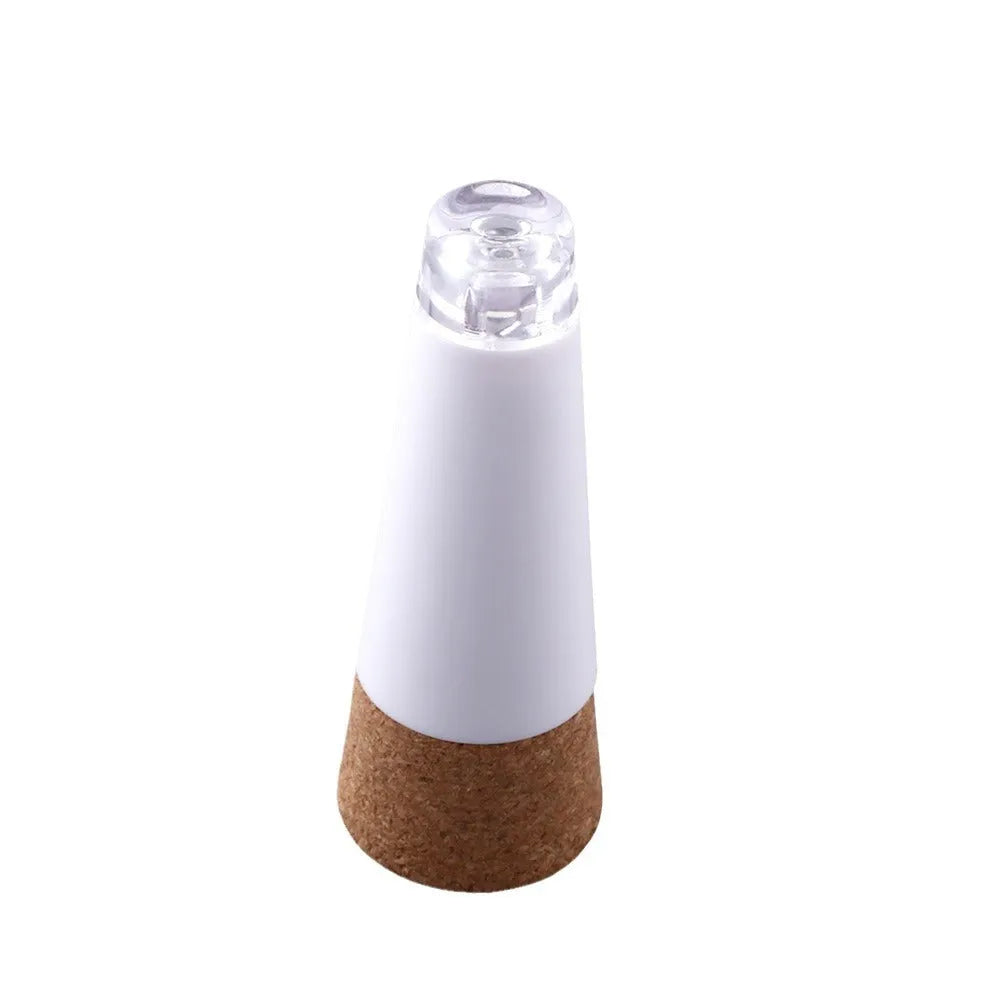 White plastic LED bottle cap light with 15 LEDs, shown on a wine bottle neck for decoration.