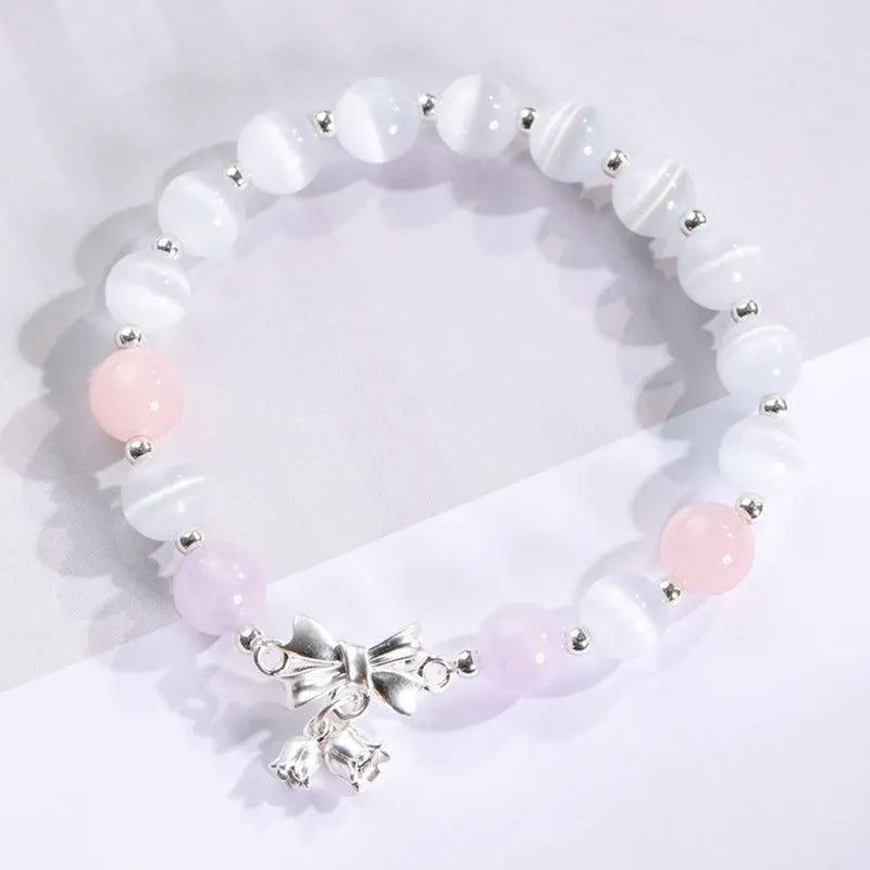 Close-up of electroplated opal cat's eye beaded bracelet for women with diamond-shaped charm