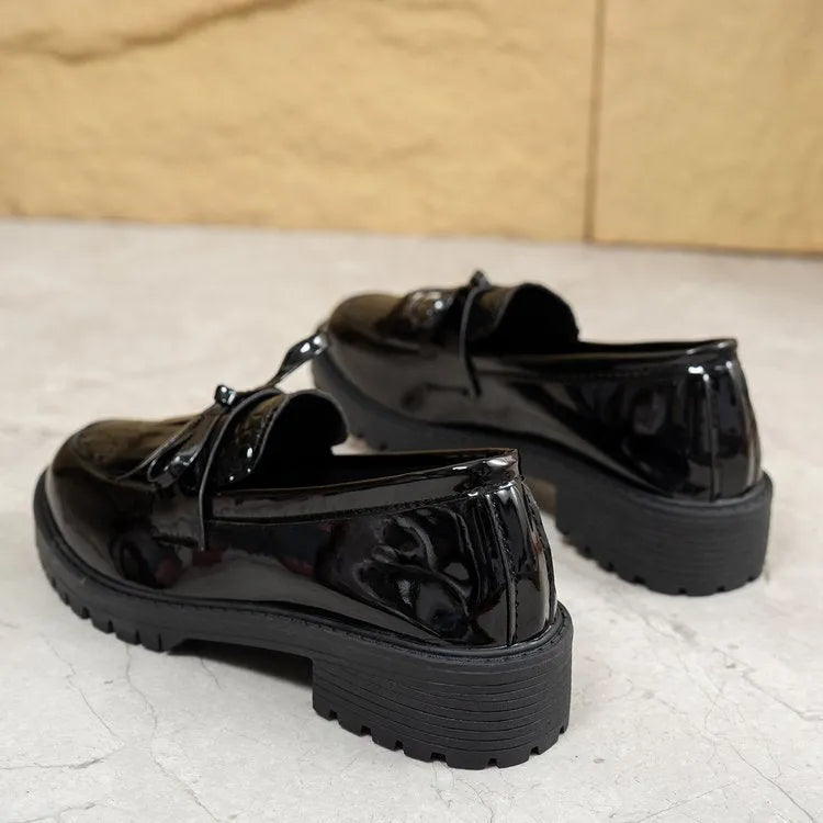Women's black loafers with a decorative bow detail on the upper.