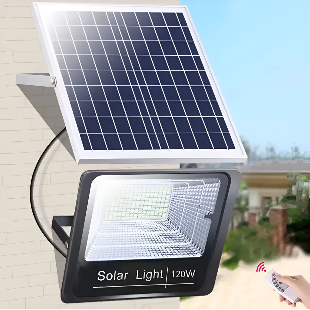 Black solar-powered LED flood light with motion sensor mounted on a wall bracket in a garden setting.