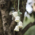 Green and white knitted wool car plant decoration with basin base and hanging rope