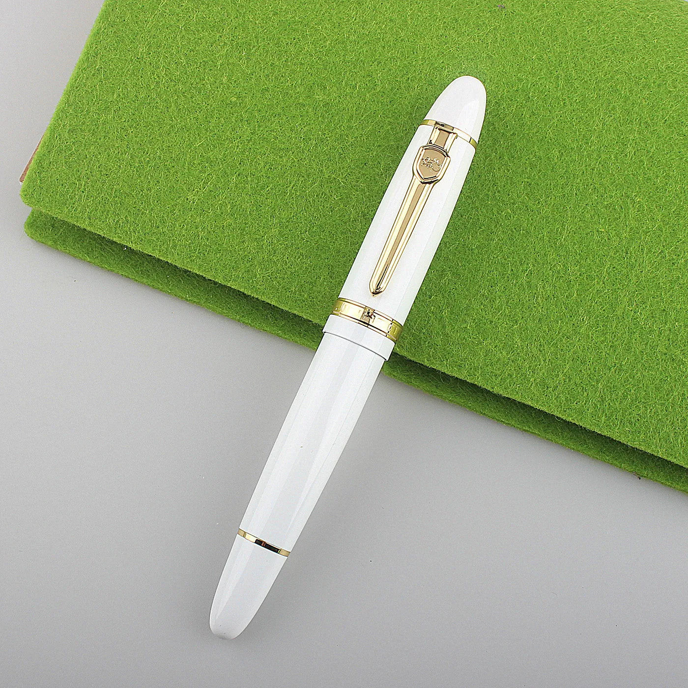 Metal ball pen with pearl round beads and black gold clip on white background
