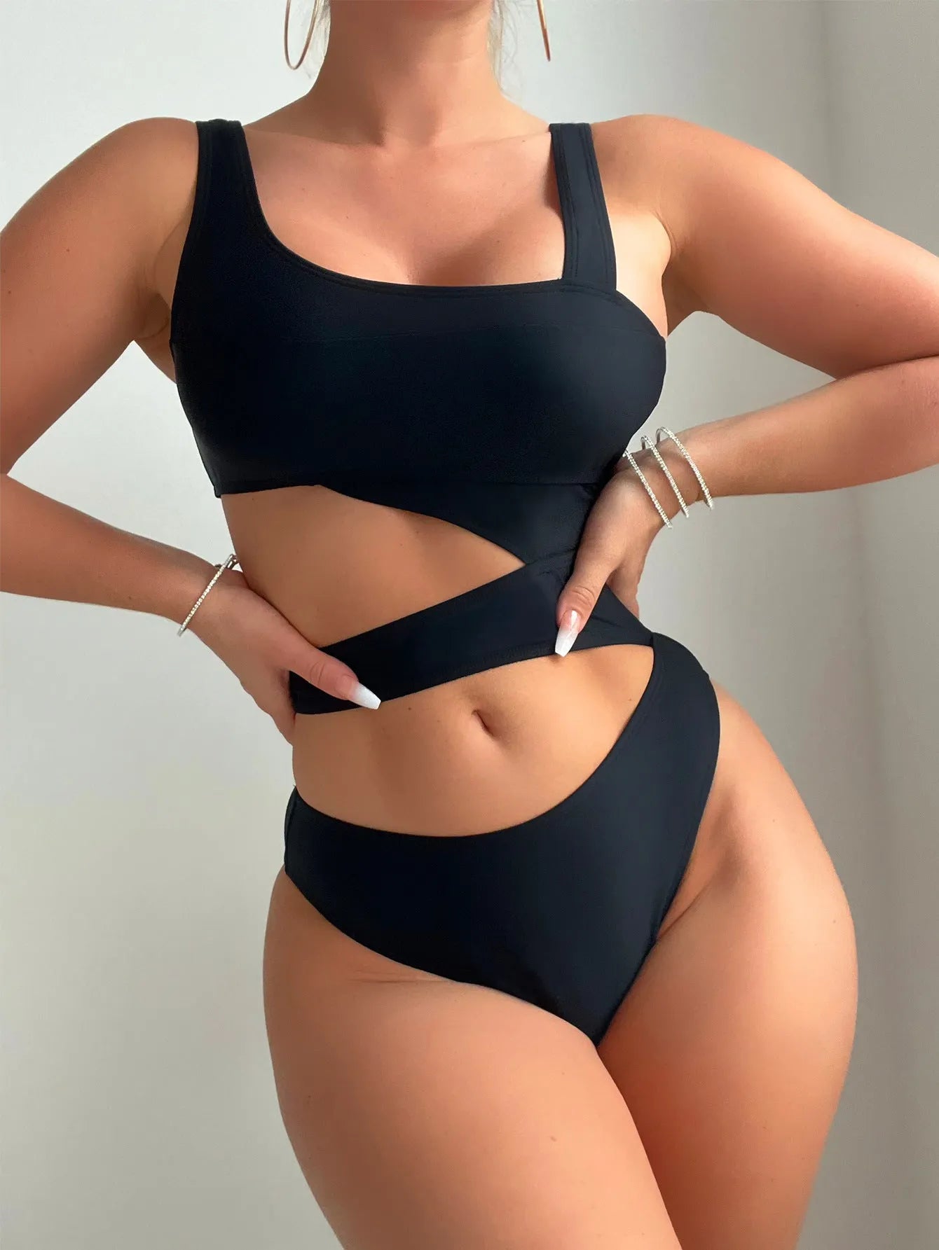 Black solid colour women's one-piece swimsuit with a high cut Siamese style and sleeveless design.