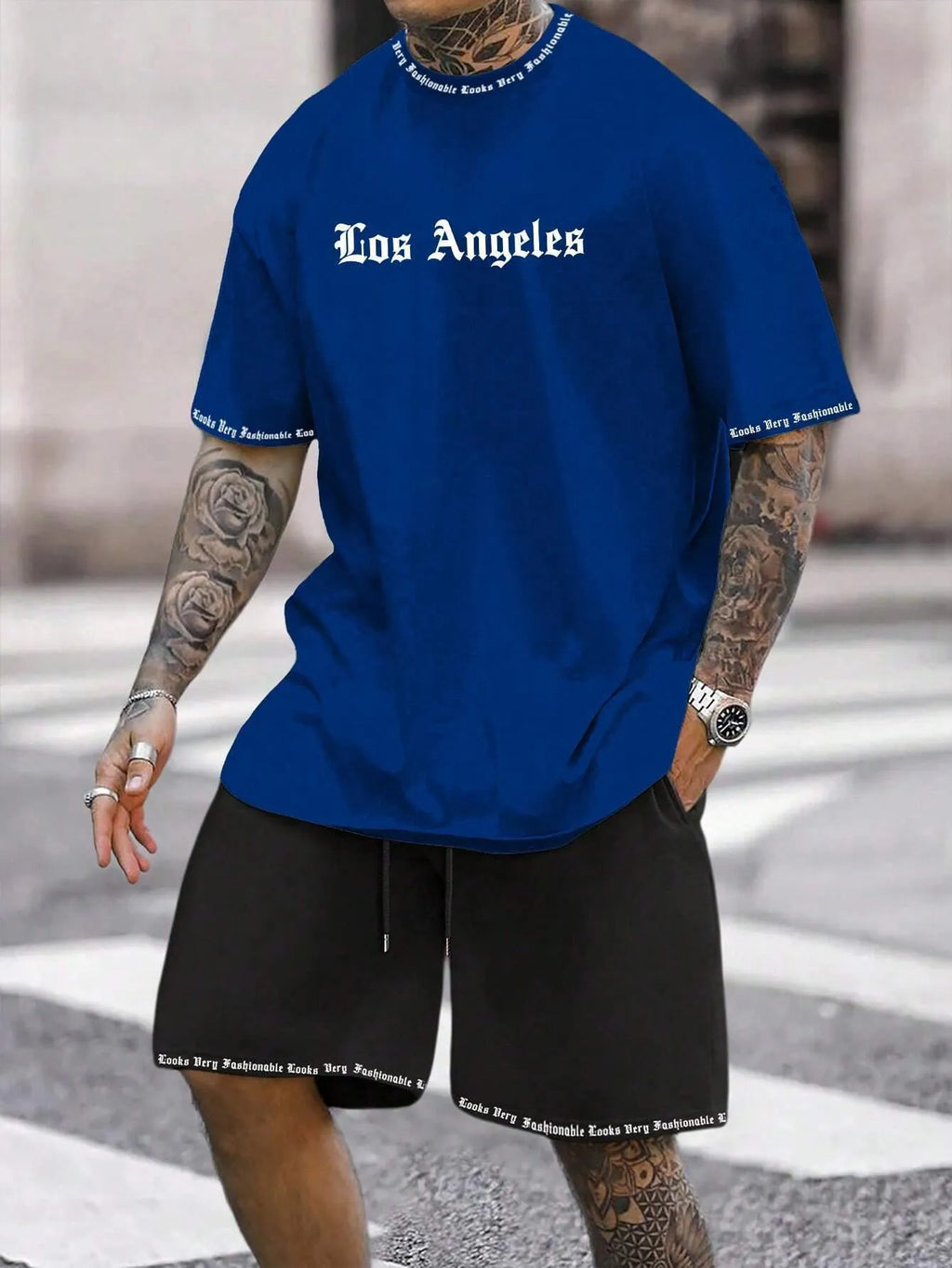 Men's blue sports style short-sleeved top and matching shorts laid flat