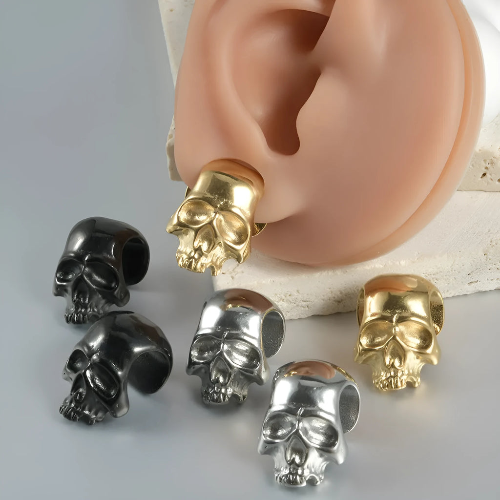 Close-up of personalised stainless steel hollow skull Buddha earrings in hip-hop style.