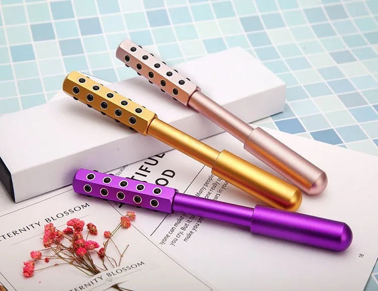 Purple Germanium particle handheld roller massager for face and eyes.