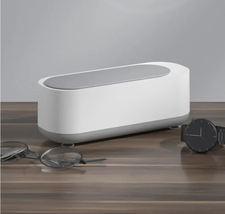 Off-white ultrasonic cleaning machine with stainless steel tank for jewellery and glasses.