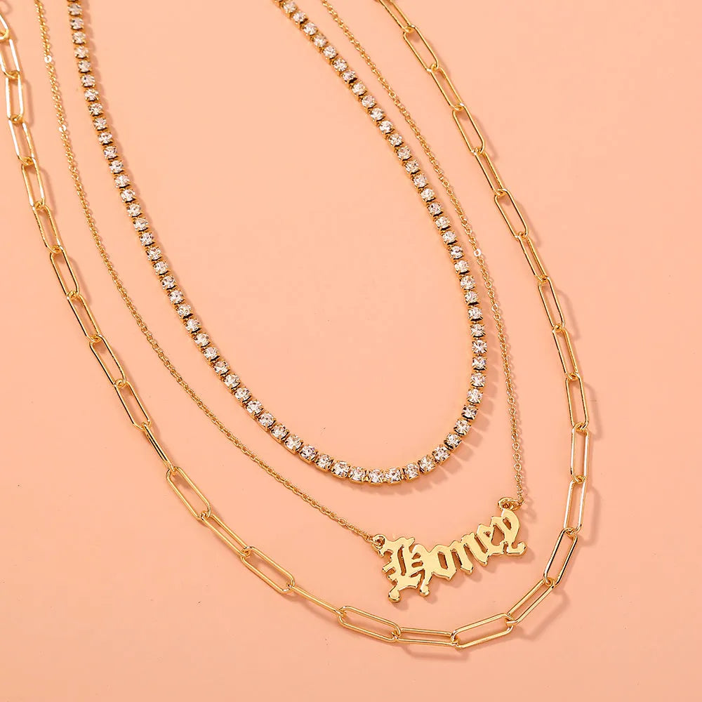 Monogram pendant multi-layer necklace on display showing electroplated zinc alloy chain and personalised initial