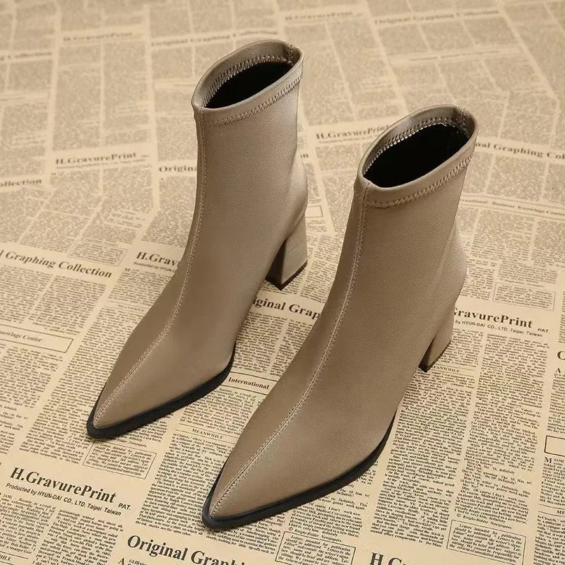 Women's khaki pointed toe ankle boots with a wedge heel on a white background.