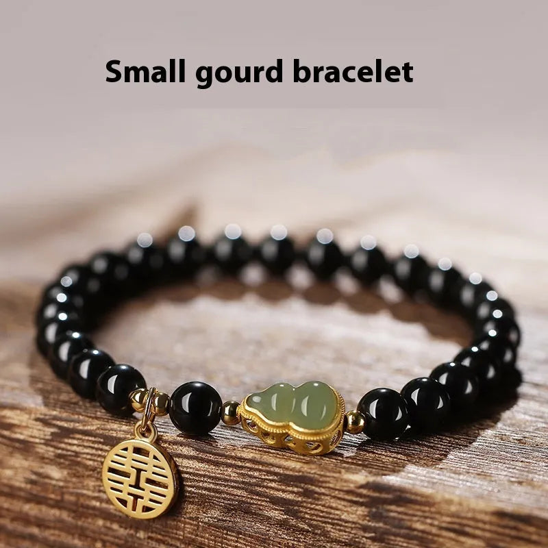 Black obsidian bracelet with a Hetian jade gourd charm, shown in couple style with geometric beads.