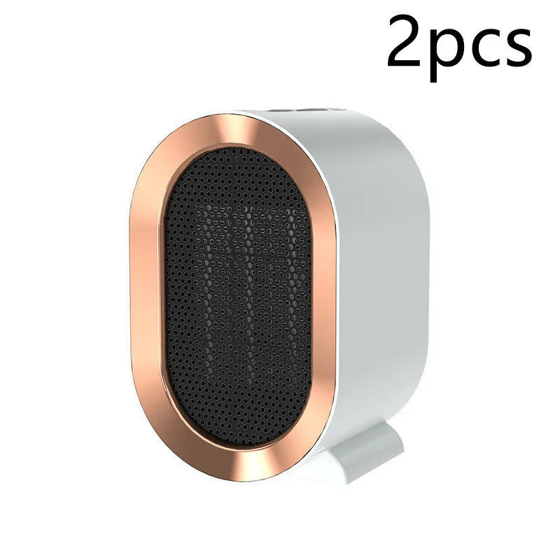 Compact black desktop electric fan heater with a front grille and mechanical control dials.