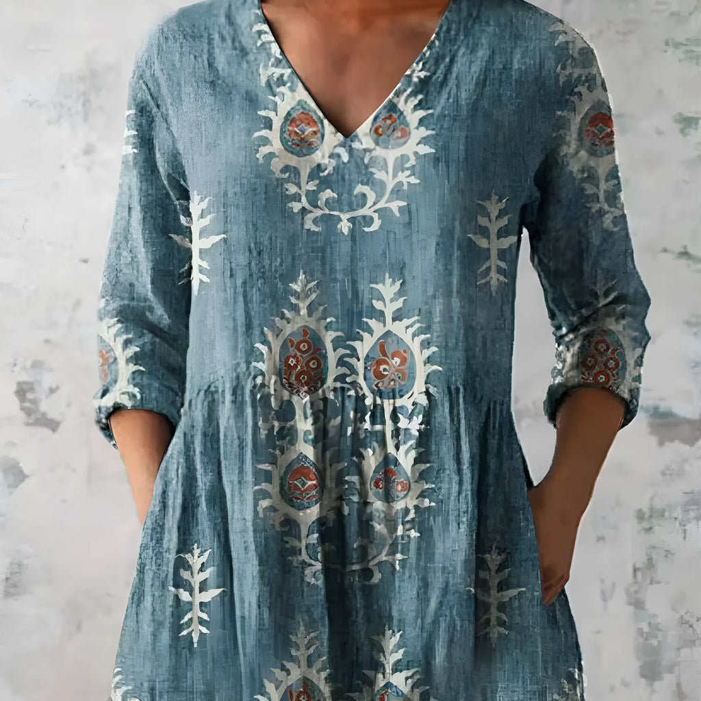 A loose-fitting women's dress with a wave print, 3/4 sleeves, and a wide waist.