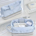 Fashion student pencil case in beige, blue, and navy blue, showing double layer open design.