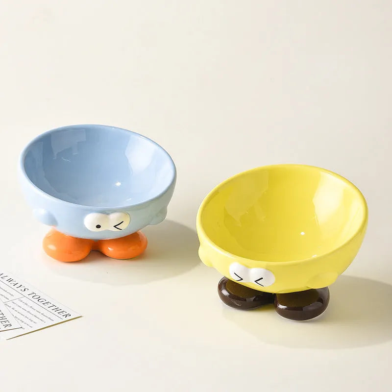 Ceramic pet bowl with oblique design and cute expressions for cervical spine protection