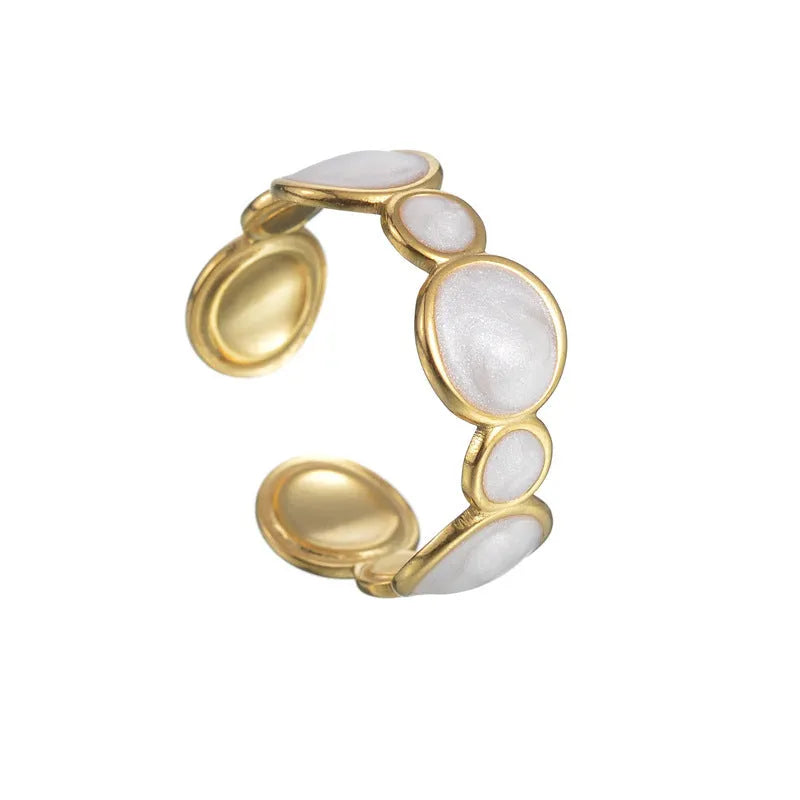 Adjustable geometric ring in stainless steel with a light luxury electroplated finish on a grey background.