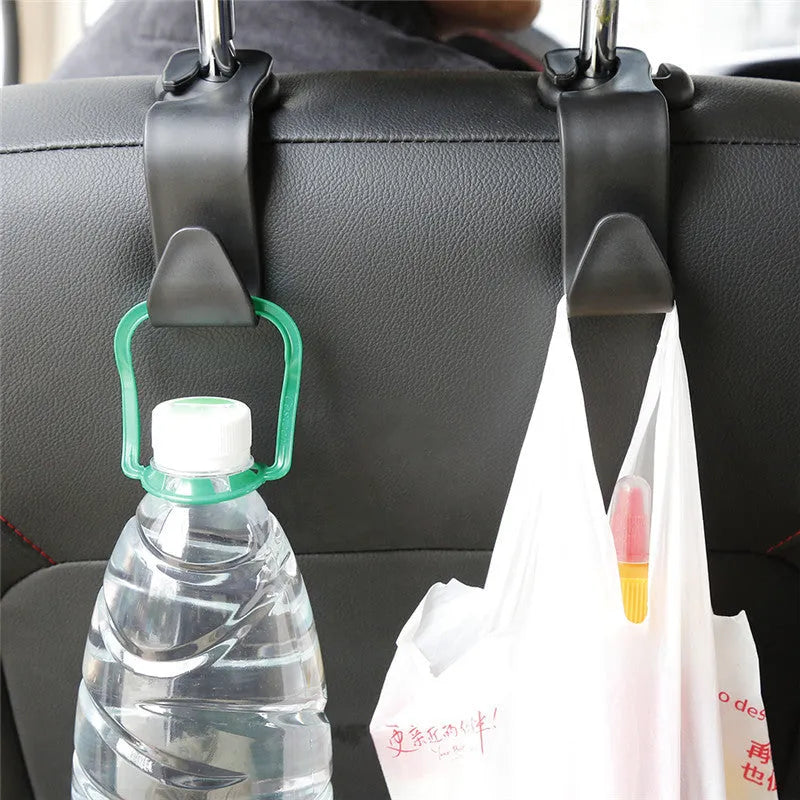 Set of four black PP plastic universal car seat back hooks on a car front seat backrest