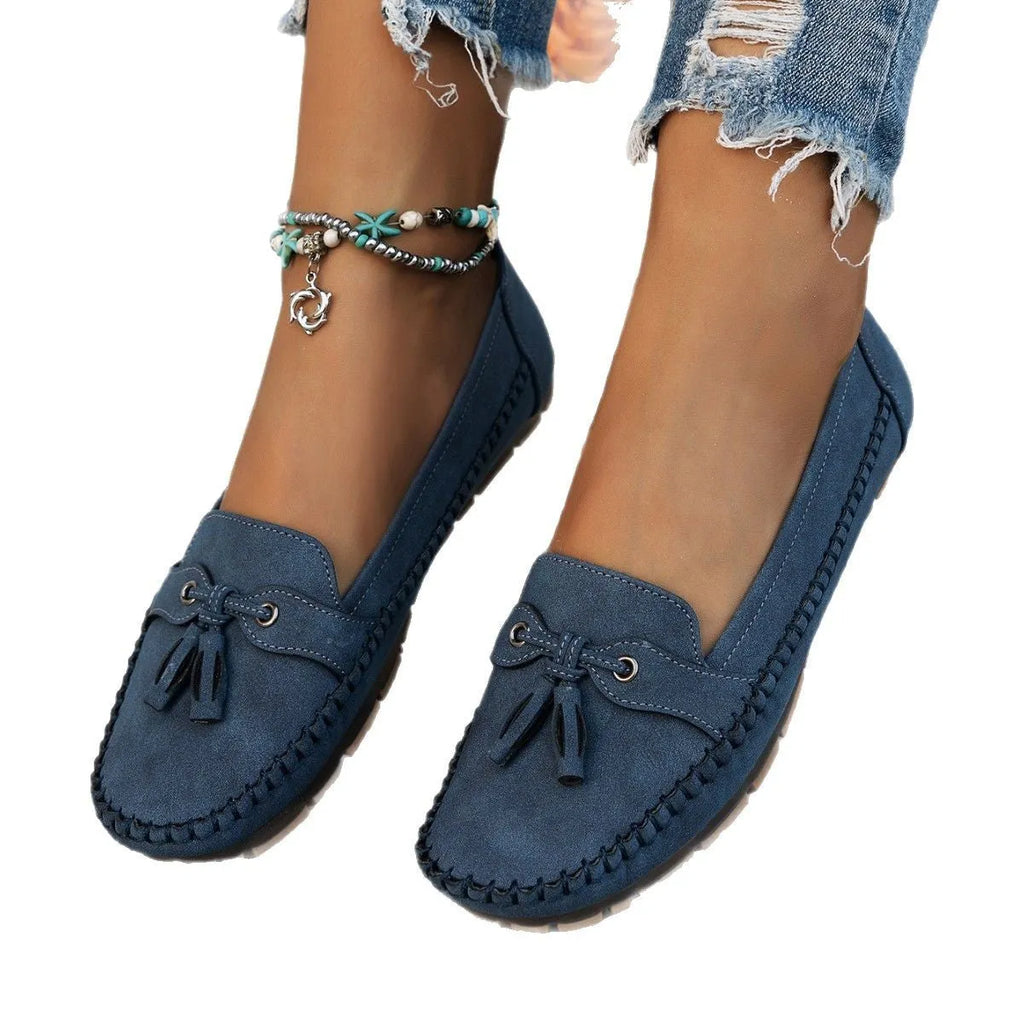 Women's casual suede flat shoes with a bow decoration, shown in a solid colour with a round toe and low heel.