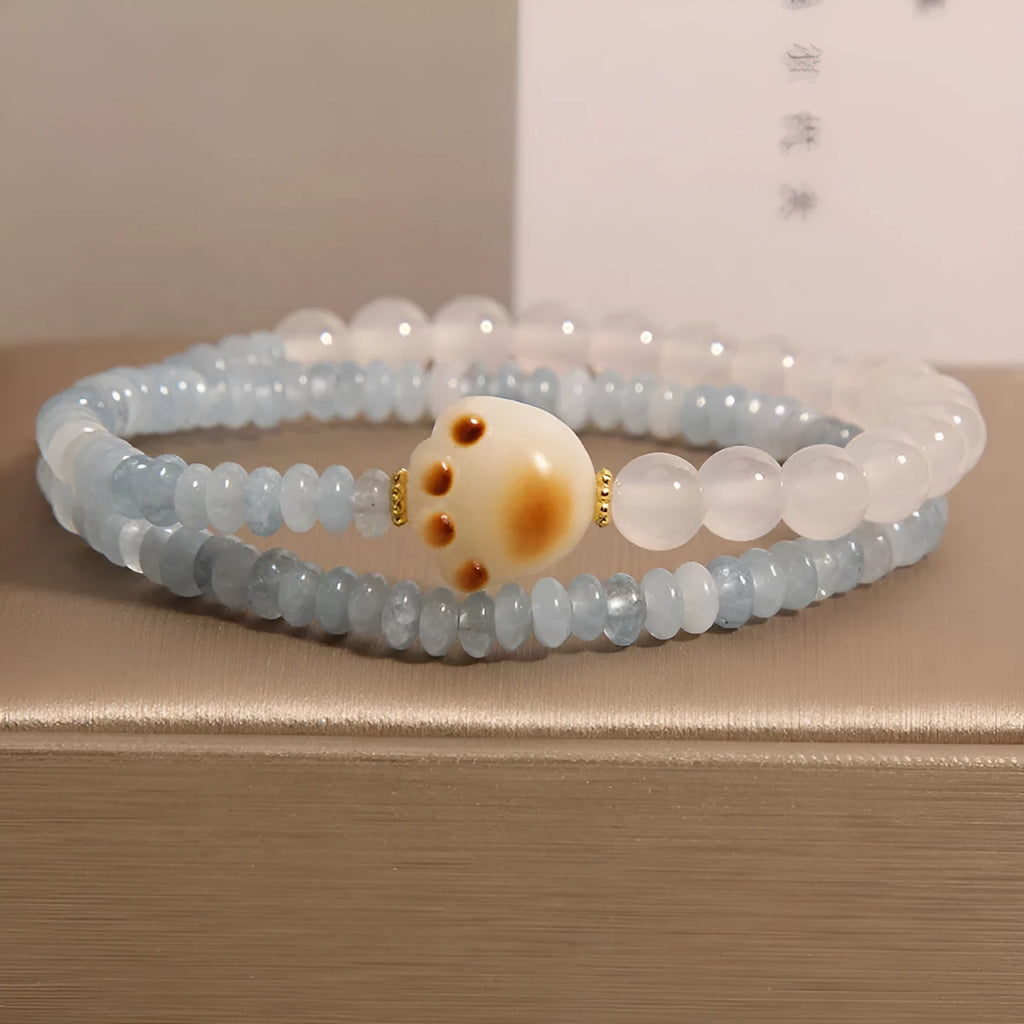 Women's crystal bracelet with aquamarine abacus beads, white agate, and cat's paw accents in double ring design