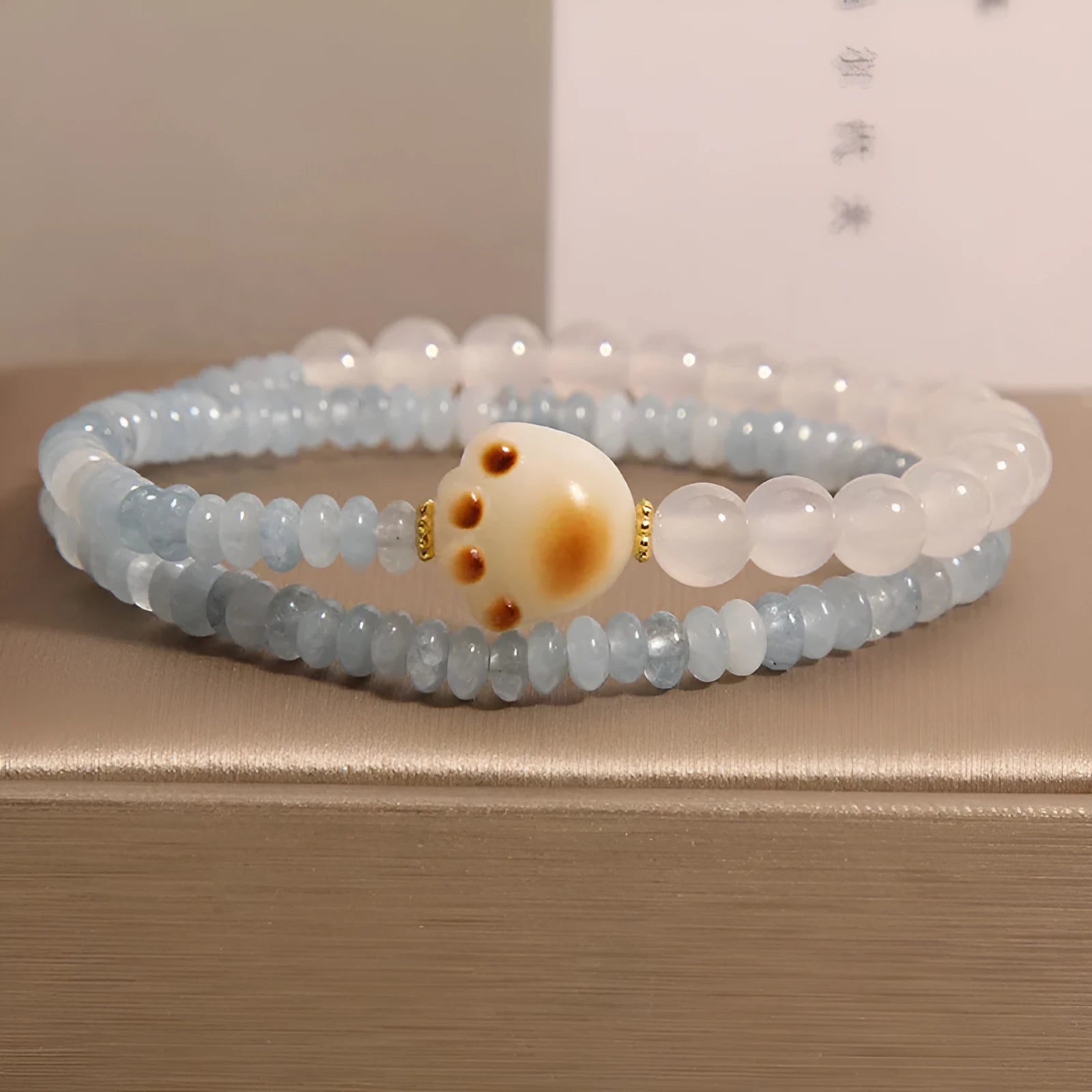 Women's crystal bracelet with aquamarine abacus beads, white agate, and cat's paw accents in double ring design