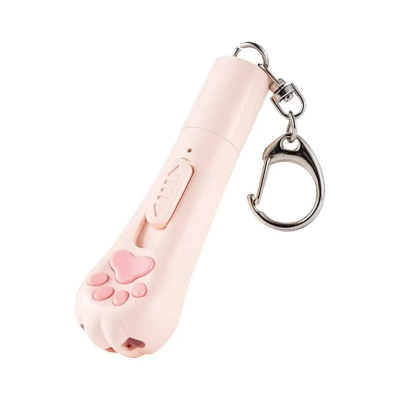 Cream white plastic cat teaser wand with laser light and attached fabric catnip pouch on a table.
