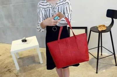 Simple fashion shoulder bag handbag in black or grey with adjustable crossbody strap and top handle