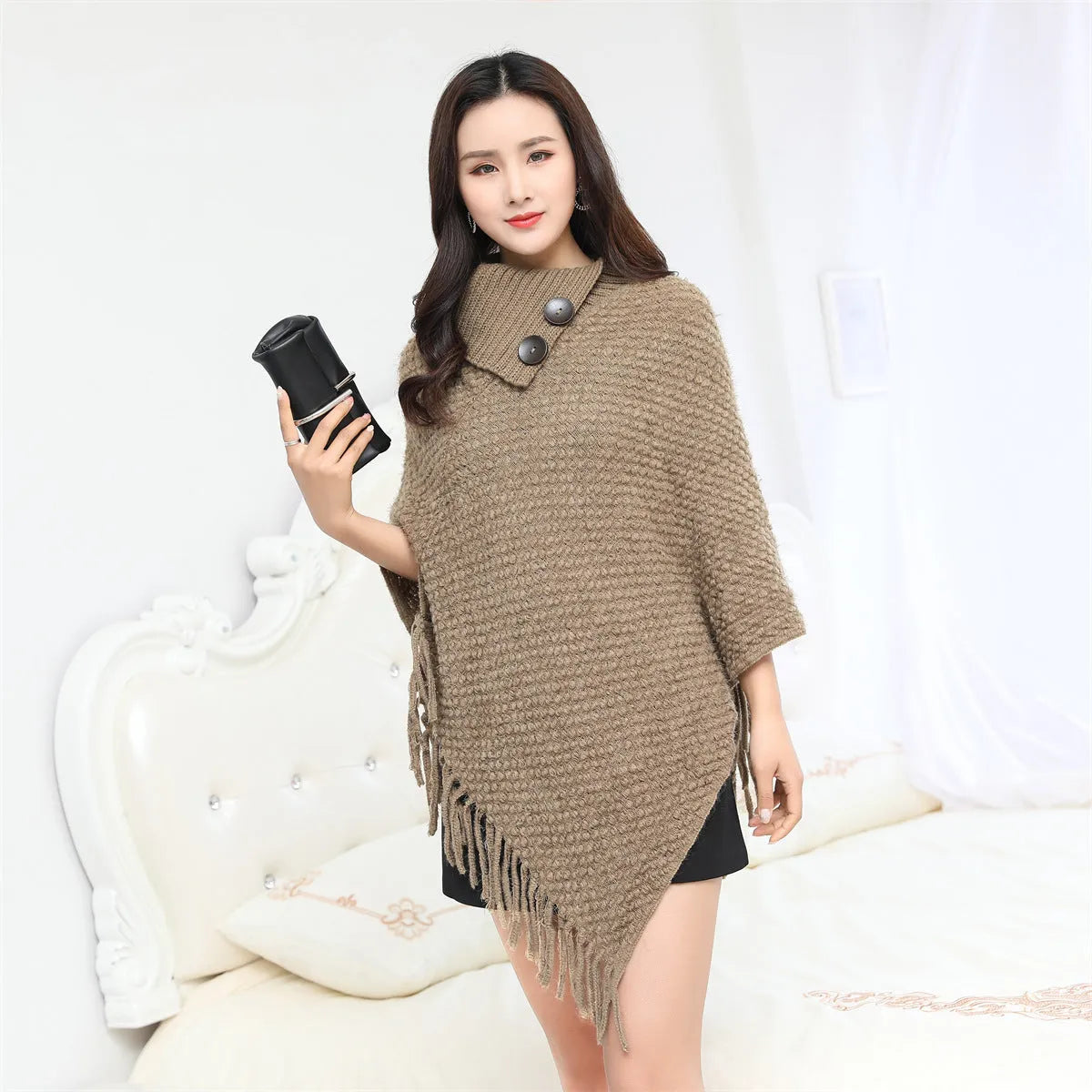 Women's dotted pattern sleeveless knit cloak shawl in acrylic fibre, shown in apricot colour.