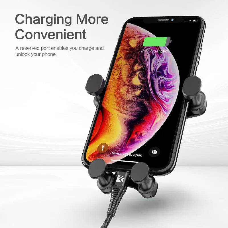 Black gravity car phone holder mounted on a car air vent, showing 360-degree rotation mechanism