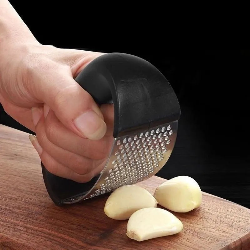 Stainless steel manual garlic press with ergonomic handle in assorted colours