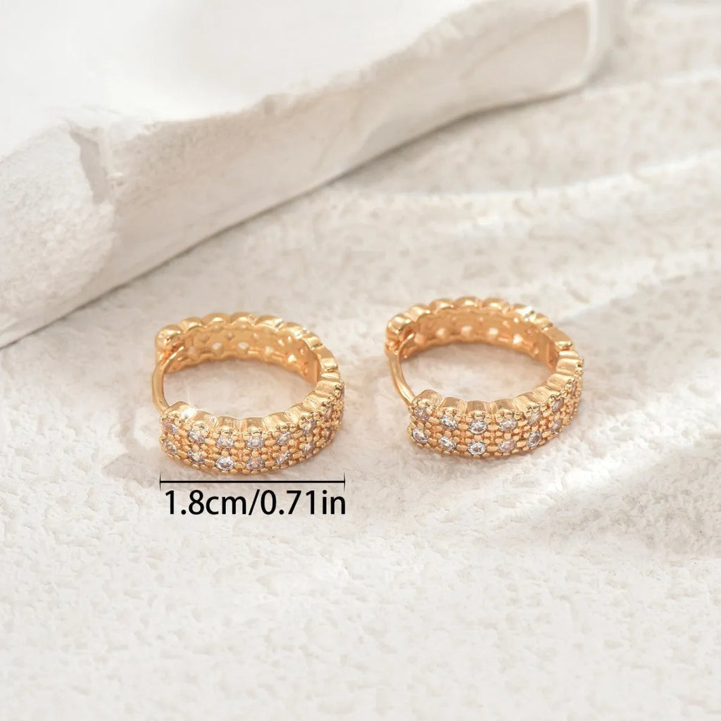 Copper geometry pattern stud earrings with round, dot, and ring details on a white background.