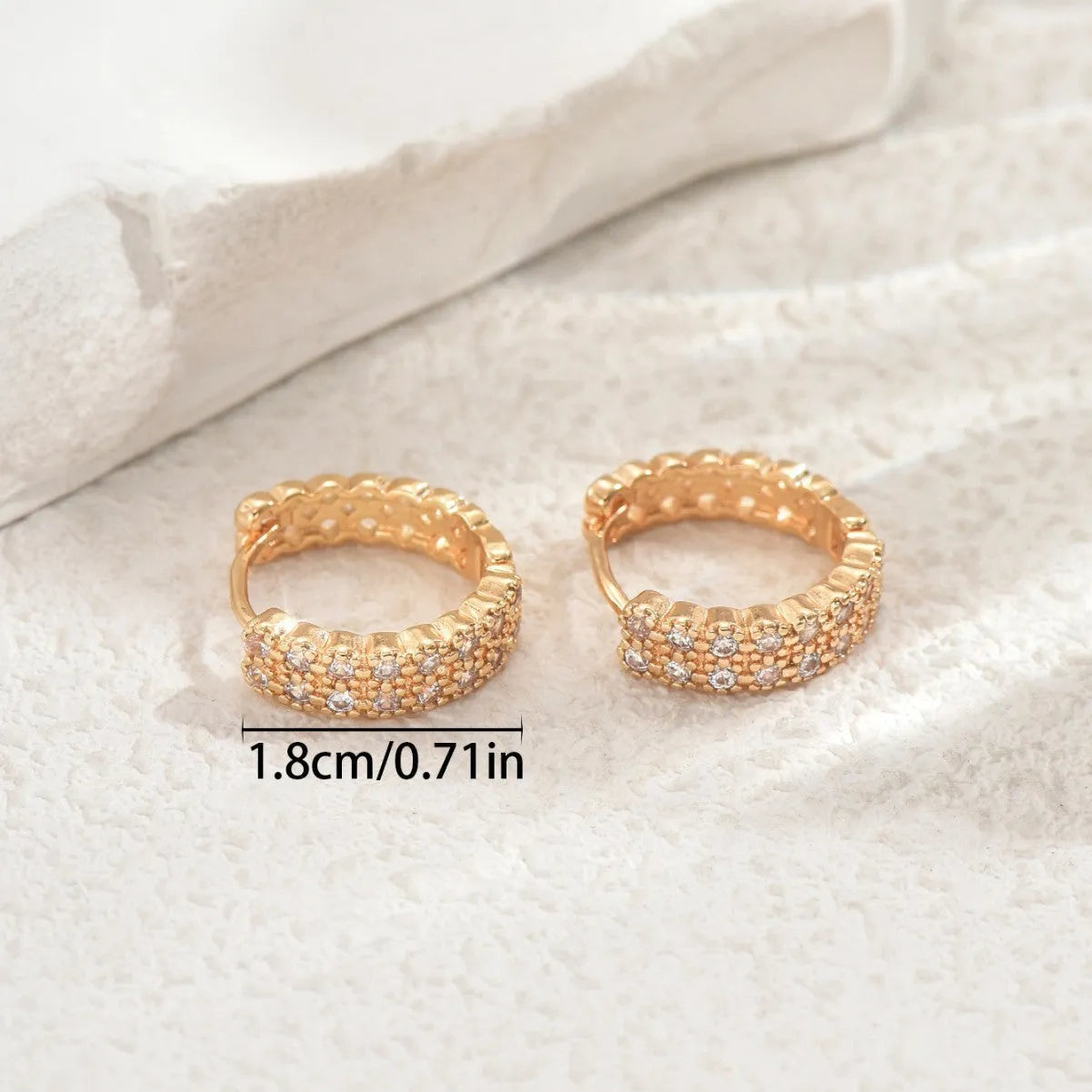 Copper geometry pattern stud earrings with round, dot, and ring details on a white background.