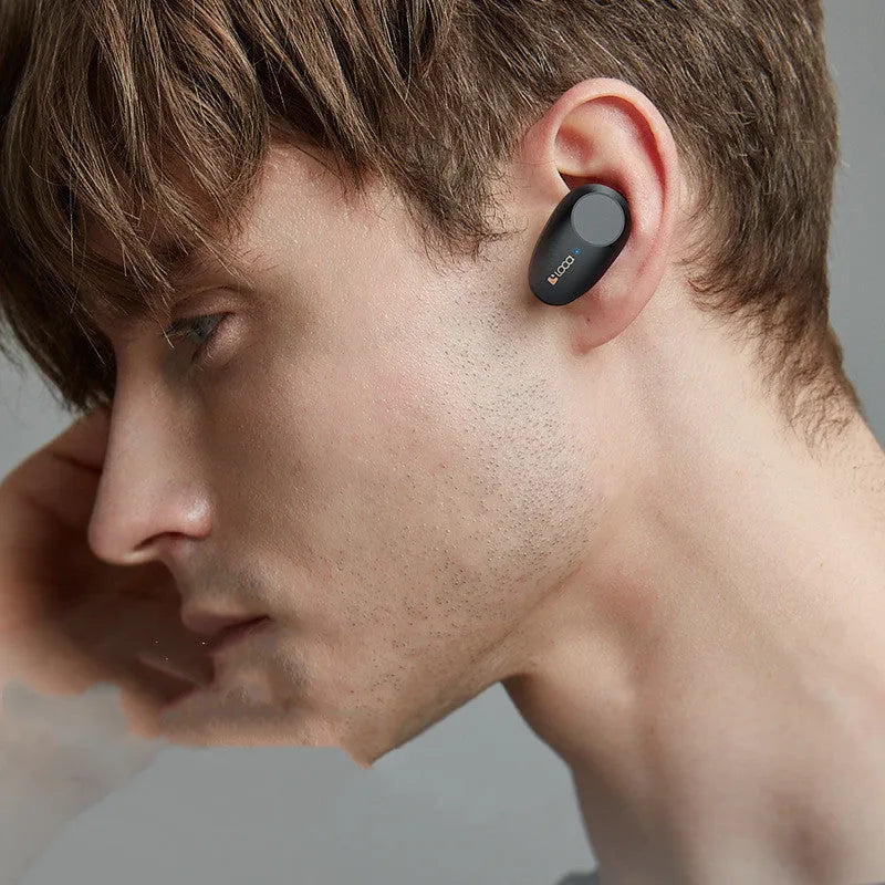 Black wireless Bluetooth headset with earbuds and charging stand featuring ANC noise reduction