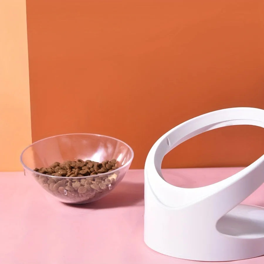 White elevated clear plastic cat food bowl with a tilted feeding surface for neck support.