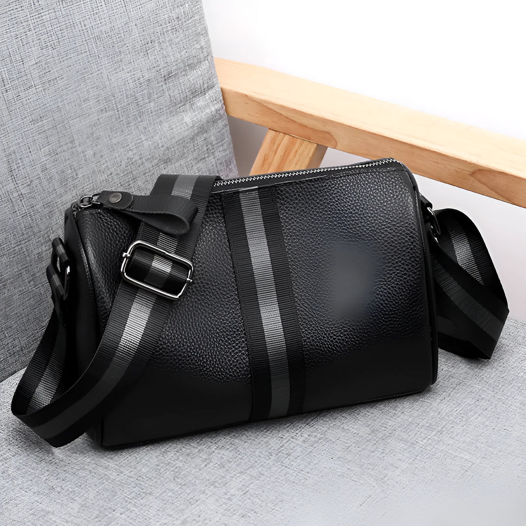 Black genuine leather crossbody bag with dimensions 24x16x13cm showing large capacity and polyester lining