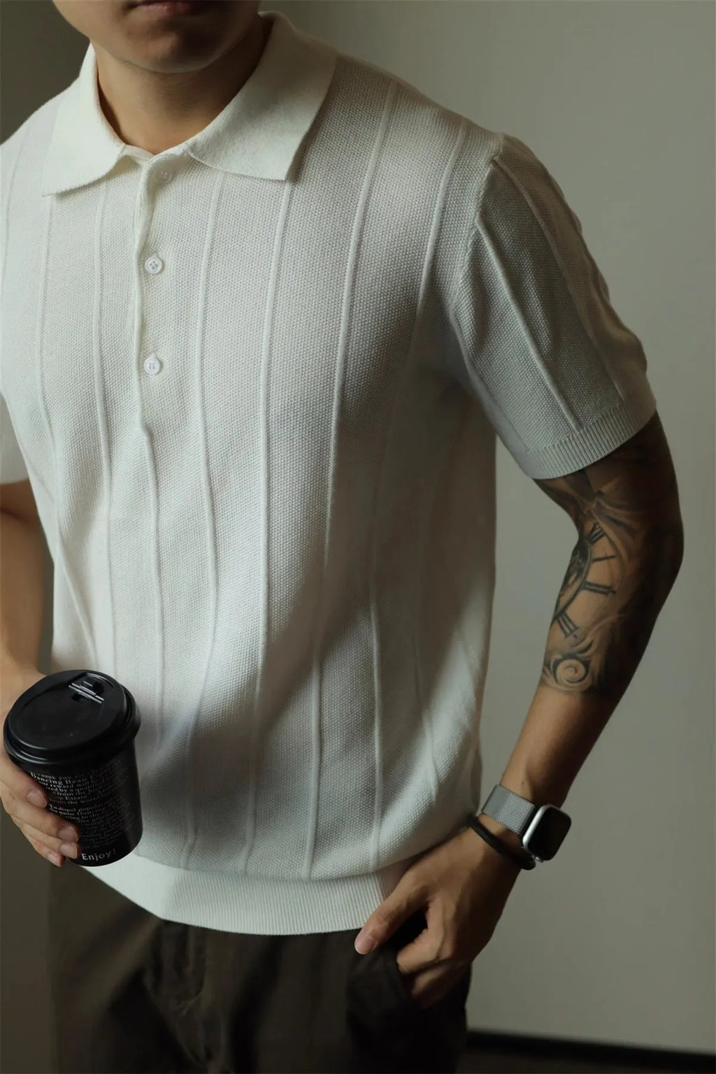 Men's solid colour loose fit polyester t-shirt on a hanger, shown in black and white.