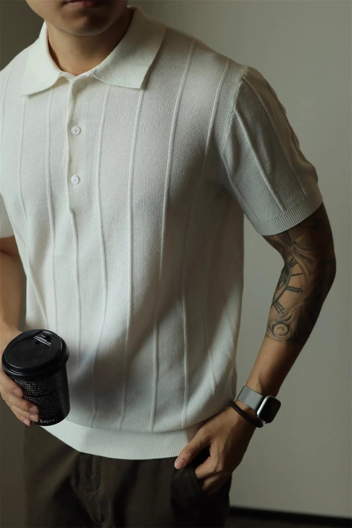 Men's solid colour loose fit polyester t-shirt on a hanger, shown in black and white.